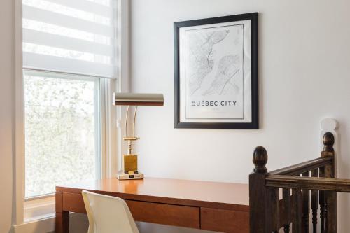 a home office with a desk and a window at Espace William by Hébergements DCL in Quebec City