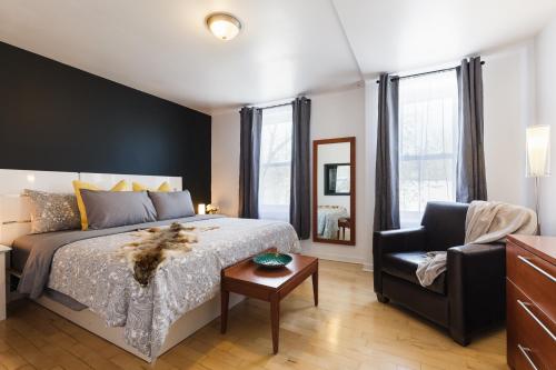 1 dormitorio con 1 cama, 1 sofá y 1 silla en Espace William by Hébergements DCL, en Quebec