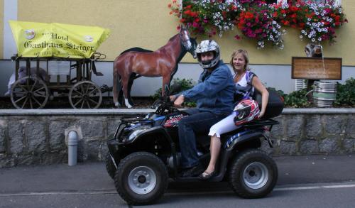 a man and a woman riding a quad bike at Hotel-Gasthaus Steiger in Gräfenthal