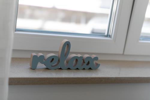 a wooden word koala sitting in front of a window at La Preziosa Rooms in Pula