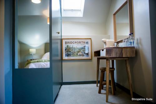 a bathroom with a mirror and a sink in a room at The Golden Lion Inn in Bridgnorth