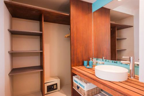a bathroom with a wooden counter with a sink at Soho Point Central in Buenos Aires