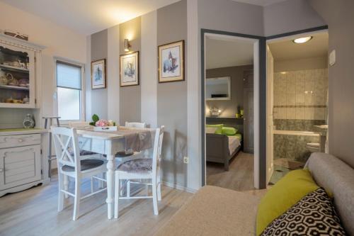 a kitchen and dining room with a table and chairs at Apartments Villa Anka in Komiža