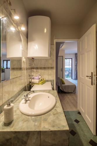 a bathroom with a sink and a mirror at Apartments Villa Anka in Komiža
