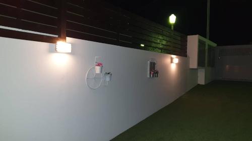 a white wall with lights on it at night at blue - comfy center rodos in Asgourou