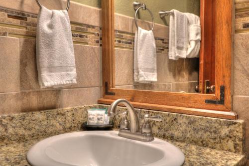 a bathroom with a sink and a mirror and towels at Gatlinburg Inn in Gatlinburg