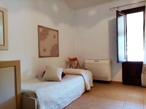 a bedroom with two beds and a window at Su Pranu in Onifai