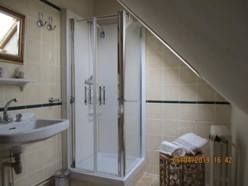 une salle de bain avec douche et lavabo dans l'établissement Le domaine de Beaufai, à Beaufai