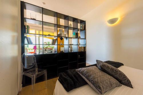 a bedroom with a bed and a book shelf at Tra gli Alberi e il Mare in Sirolo