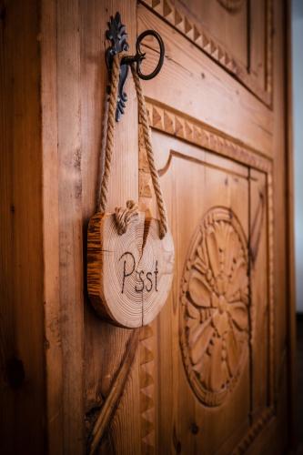 a bag is hanging on a wooden wall at Das Halali - dein kleines Hotel an der Zugspitze in Ehrwald