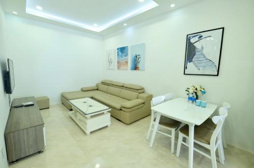 a living room with a couch and a table at Stay in Nha Trang Apartment in Nha Trang
