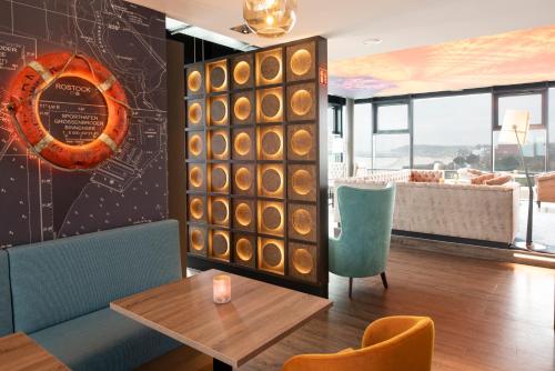 a restaurant with a table and chairs in a room at aja Grömitz in Grömitz