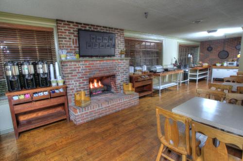 a restaurant with a brick fireplace in a room at Gatlinburg Inn in Gatlinburg