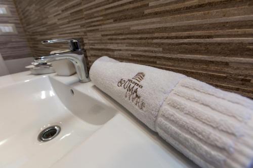 a towel is hanging on a bathroom sink at Spuma di mare in Gallipoli