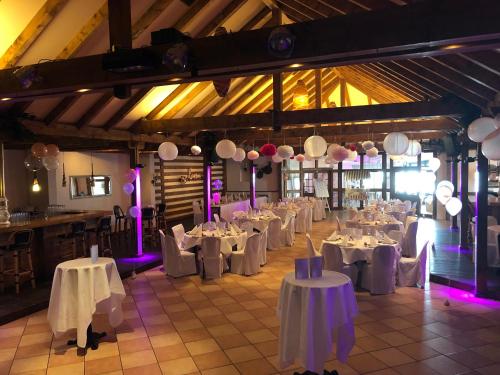 a room filled with tables and chairs with white table cloth at Burbaums Restaurant Hotel in Waltrop