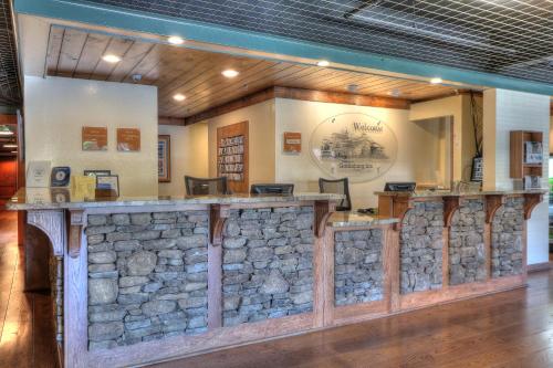 a stone bar in a lobby with a stone wall at Gatlinburg Inn in Gatlinburg