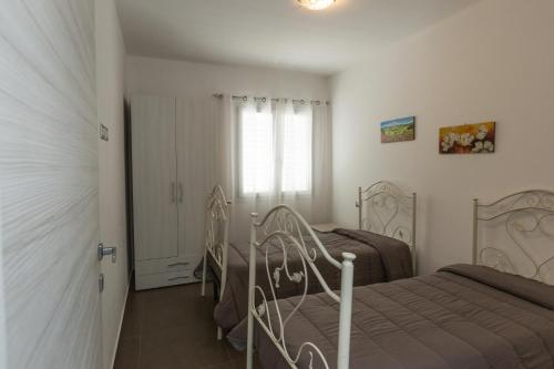 a bedroom with two beds and a window at Spuma di mare in Gallipoli
