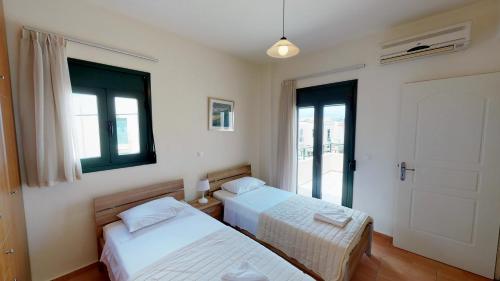 Postel nebo postele na pokoji v ubytování Villa Eleni
