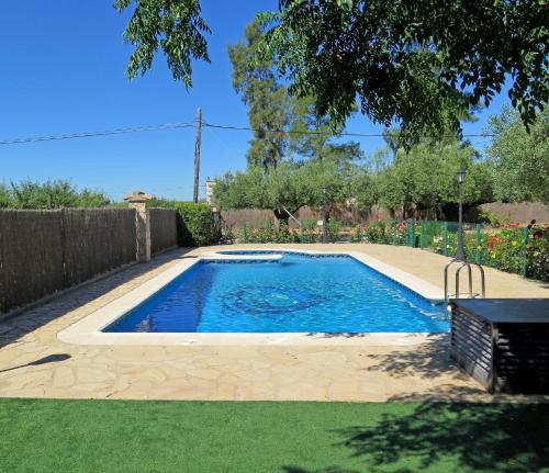 a swimming pool in a yard with a fence at Casa El Ros II - Turistrat in Vall dʼAlba