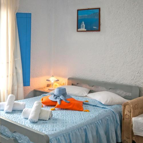a bedroom with a bed with a stuffed animal on it at Smarula Villa in Firostefani