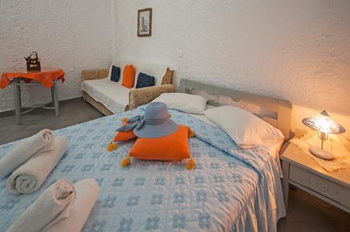 a stuffed animal sitting on top of a bed at Smarula Villa in Firostefani