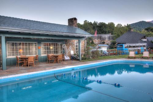 a house with a swimming pool in front of a house at Gatlinburg Inn in Gatlinburg