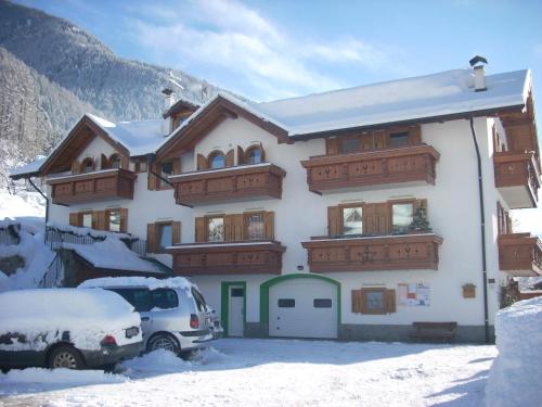a house with a car parked in front of it at Casa Bamby in Cogolo
