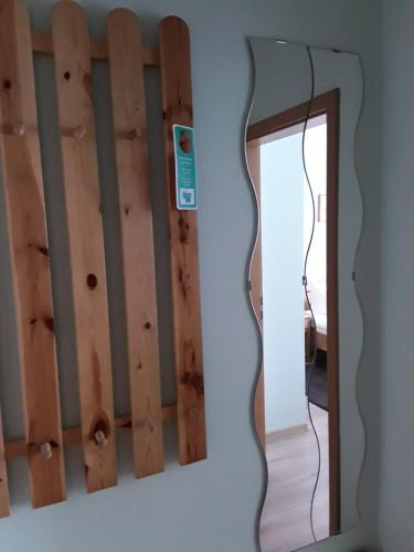 a mirror hanging on a wall next to a room at Gasthof Lindenkrug in Broderstorf