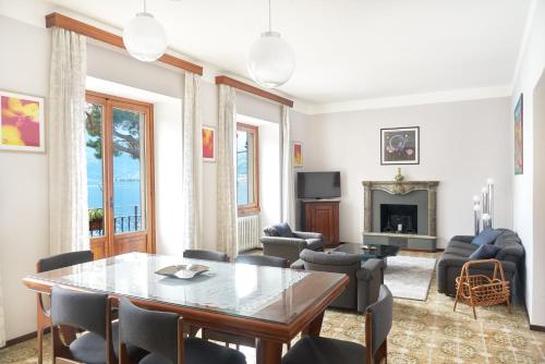 a living room with a table and chairs at Residence Domaso - Esperienza in Centro Storico "Casa del Dottore" in Domaso