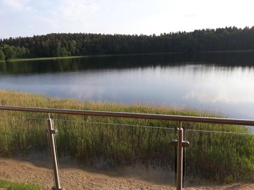 a view of a lake with a metal railing at Mazurskie Klimaty Tatarak in Olsztyn