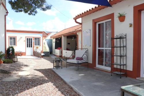 a patio of a house with a table and chairs at Casa o Futuro in Alcobaça