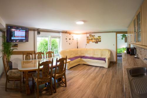 a living room with a table and a couch at Apartma na Ravnicah in Cerkno