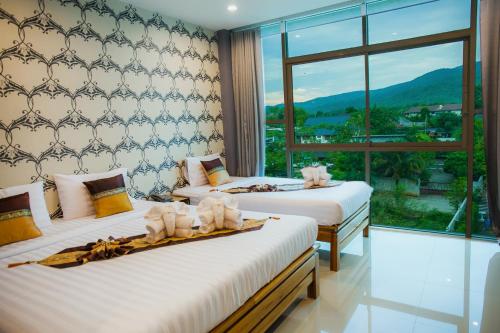 Postel nebo postele na pokoji v ubytování Km Hotel Chiang Mai