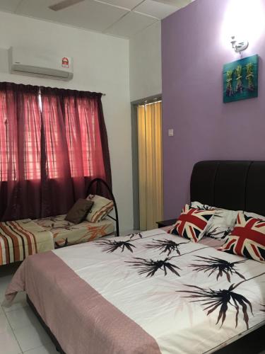 a bedroom with two beds and avertisement for at Ipoh Station 18 in Ipoh