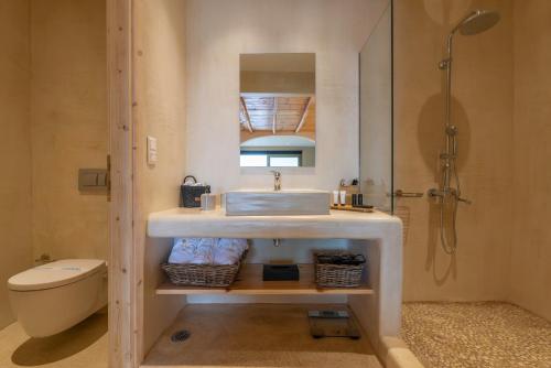 a bathroom with a sink and a toilet and a shower at Meli Suites, Thassos in Skala Potamias