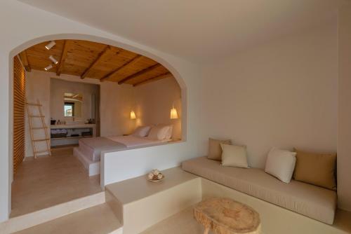 a living room with a couch and a bed at Meli Suites, Thassos in Skala Potamias
