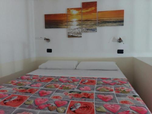 a bedroom with a bed with red roses on it at Appartamento Larghetto Licastro in Pizzo
