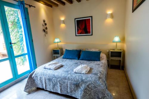 a bedroom with a bed with two pillows on it at La Ferme de L'Oudon & SPA in Berville