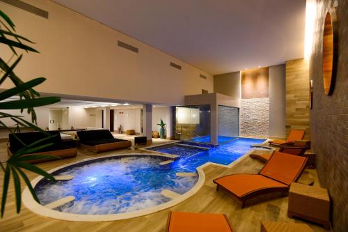 a large pool in the middle of a living room at Vogal Luxury Beach Hotel & SPA in Natal
