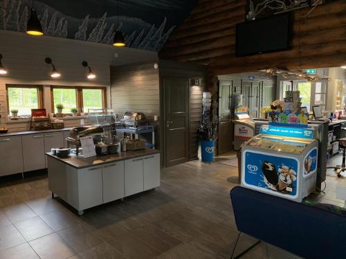 a large kitchen with a counter and a counter top at Ranua Resort Camping Ranuanjärvi in Ranua