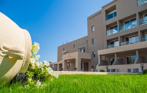 a building with green grass in front of it at CNic Gemini Hotel in Mesongi