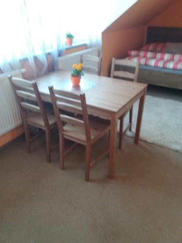 a dining room table and chairs in a room at Garden apartments in Znojmo