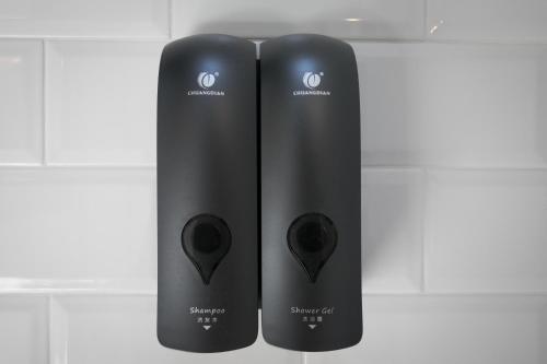 two black wii controllers are standing next to each other at Addimora Boutique Suites in Palermo