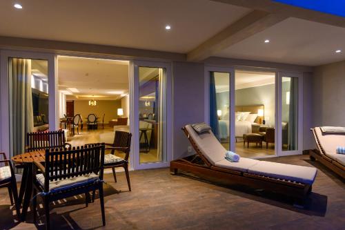 a room with two beds and a living room at Vogal Luxury Beach Hotel & SPA in Natal