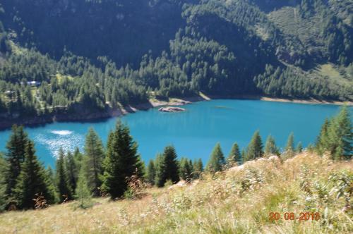 a view of a blue lake in the mountains at Casa Bamby in Cogolo