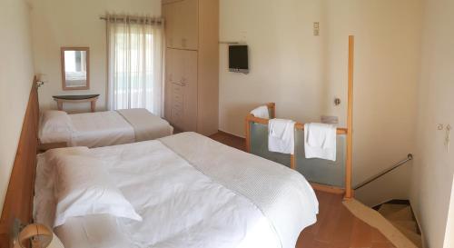 Säng eller sängar i ett rum på Christopoulos Villas