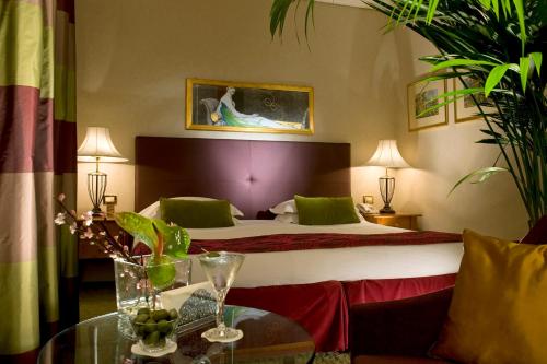 a hotel room with a bed and a table at Hotel dei Mellini in Rome
