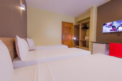 Ένα ή περισσότερα κρεβάτια σε δωμάτιο στο Safira Praia Hotel