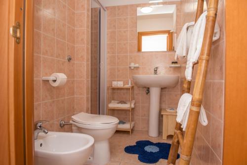 a bathroom with a toilet and a sink at Al Faro Guest House in Vieste