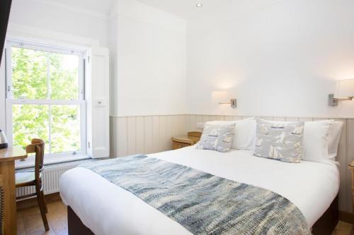 a bedroom with a large bed and a window at Hotel Continental in Whitstable